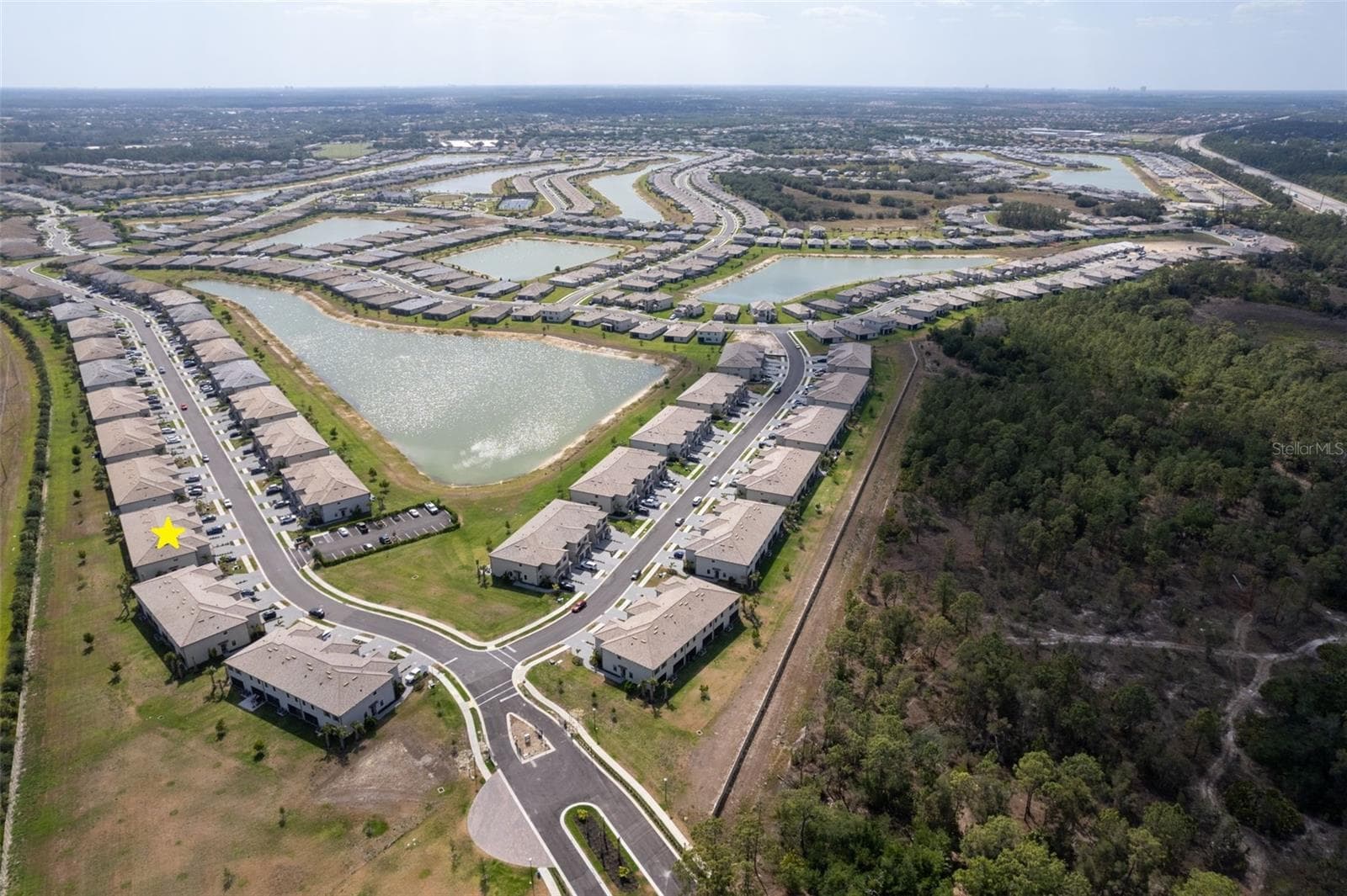 Aerial view showcasing the home’s prime location within the beautifully planned Timber Creek community, surrounded by scenic lakes and green spaces and located outside a designated flood zone - 14275 PINE LODGE LN, FORT MYERS