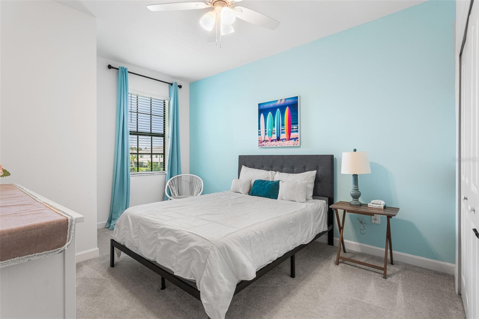 Bright third bedroom featuring a cheerful accent wall, ceiling fan, generous closet space, and plenty of natural light - 14275 PINE LODGE LN, FORT MYERS