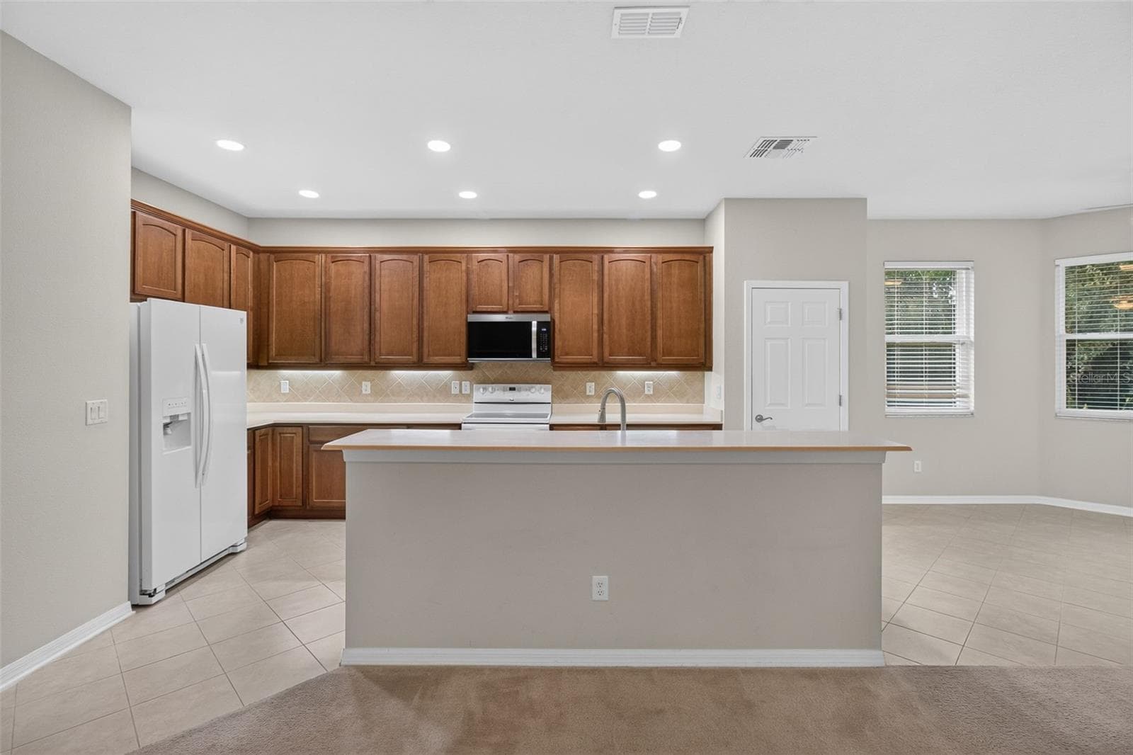 Kitchen with Breakfast Bar and all Corian Countertops - 11156 MERGANSER WAY, NEW PORT RICHEY