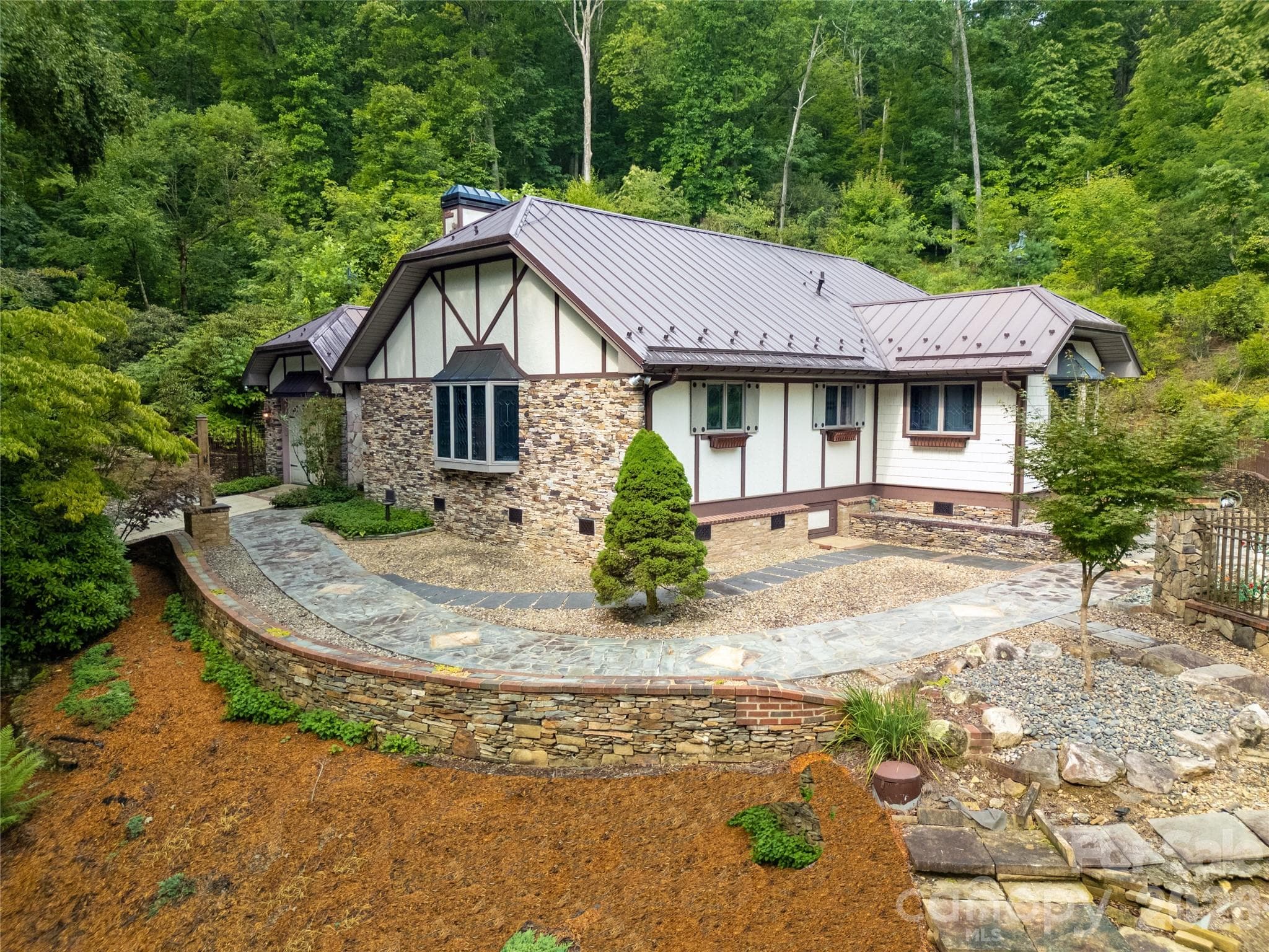 House and Outdoor Setting from the air on the right side. Tremendous amount of beautiful stone walls, stone paths and rock settings surround the entire house. No mowing! - 275 Hubbard Hollow Road, Rosman