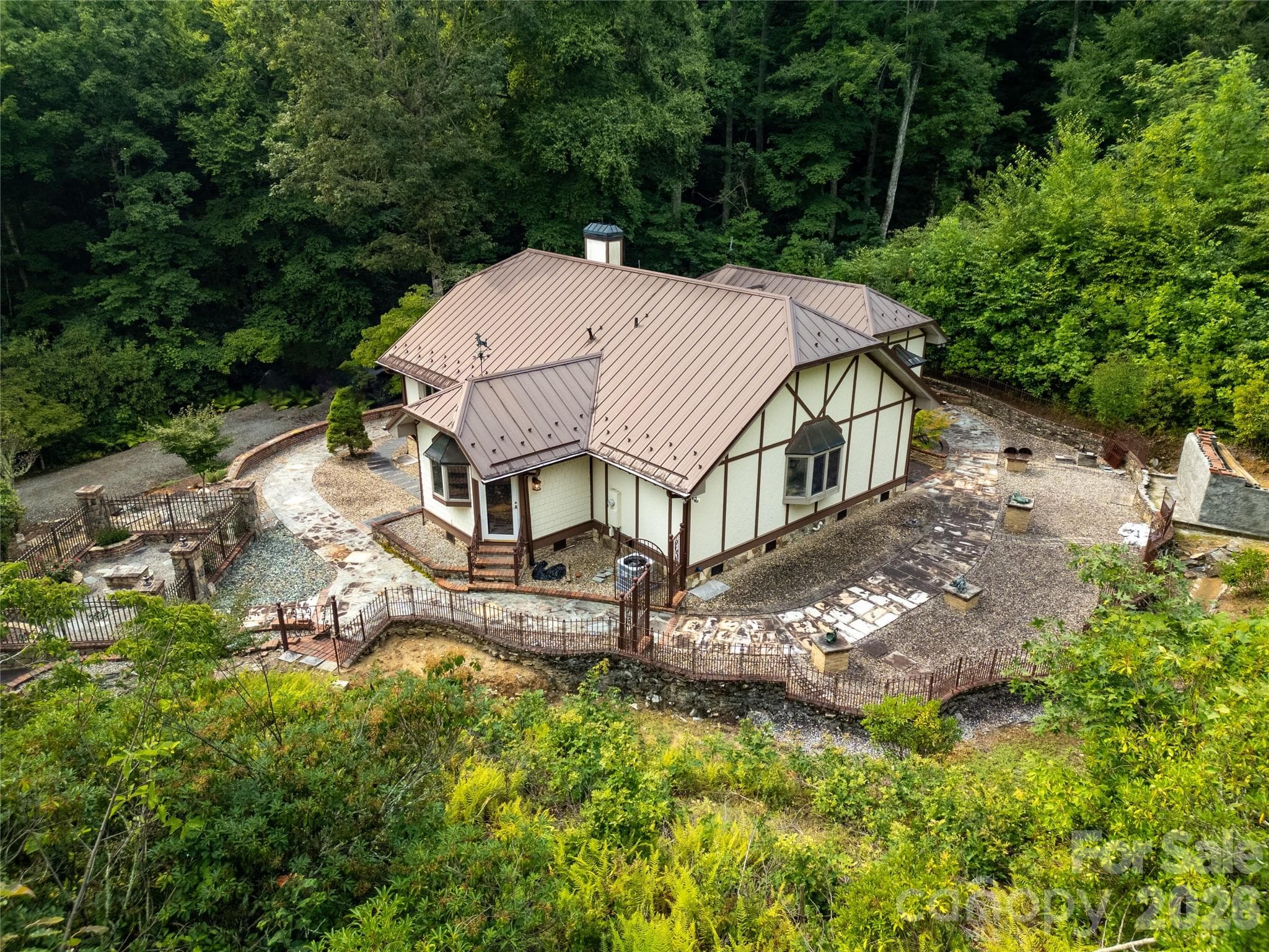 Looking here at the back of the house from the air! Lady Bugs Garden on far left, and Lady Bugs Custom Fountain Waterfall (unfinished) on far right! - 275 Hubbard Hollow Road, Rosman