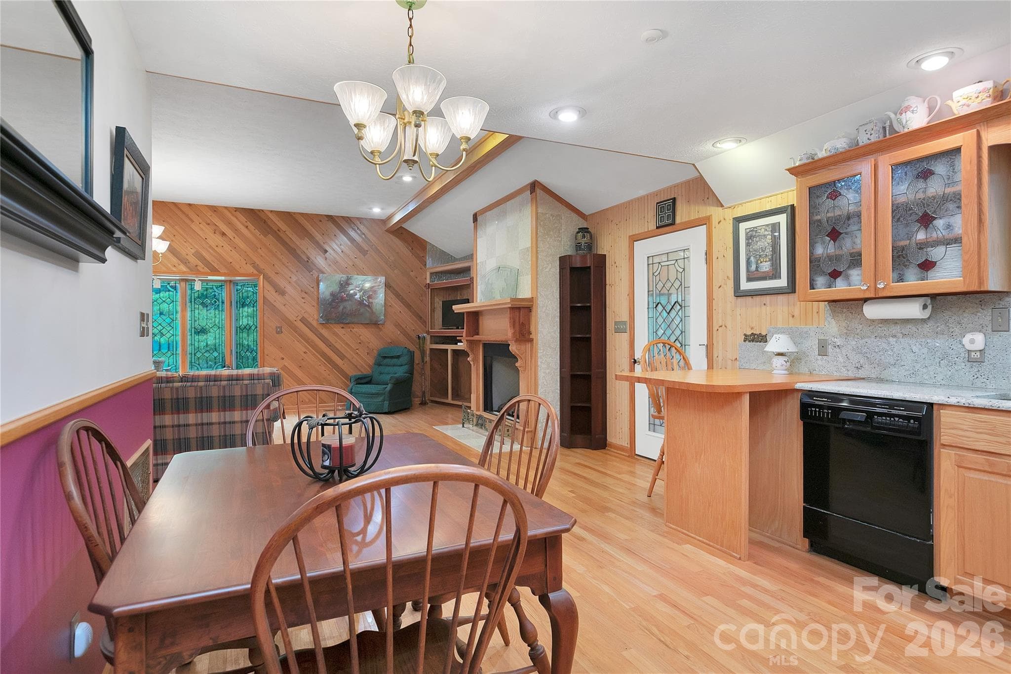 Looking back across the table here to the living room fireplace and the door to the entry way / foyer. - 275 Hubbard Hollow Road, Rosman