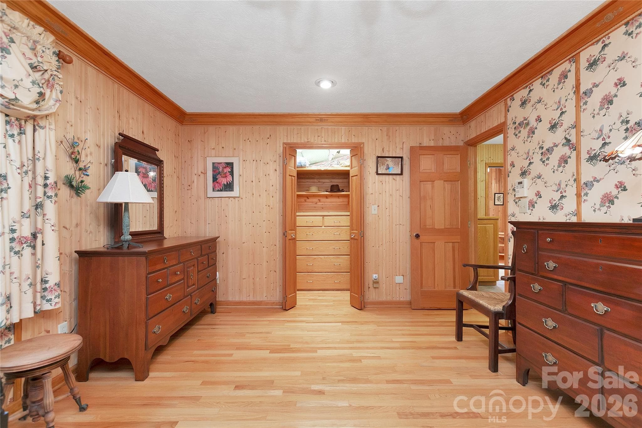 Primary bedroom has a walk-in closet with his and her sides. Door on the right goes into the laundry room and primary bathroom, separate rooms!can come complete with all the eloquent furnishings! - 275 Hubbard Hollow Road, Rosman
