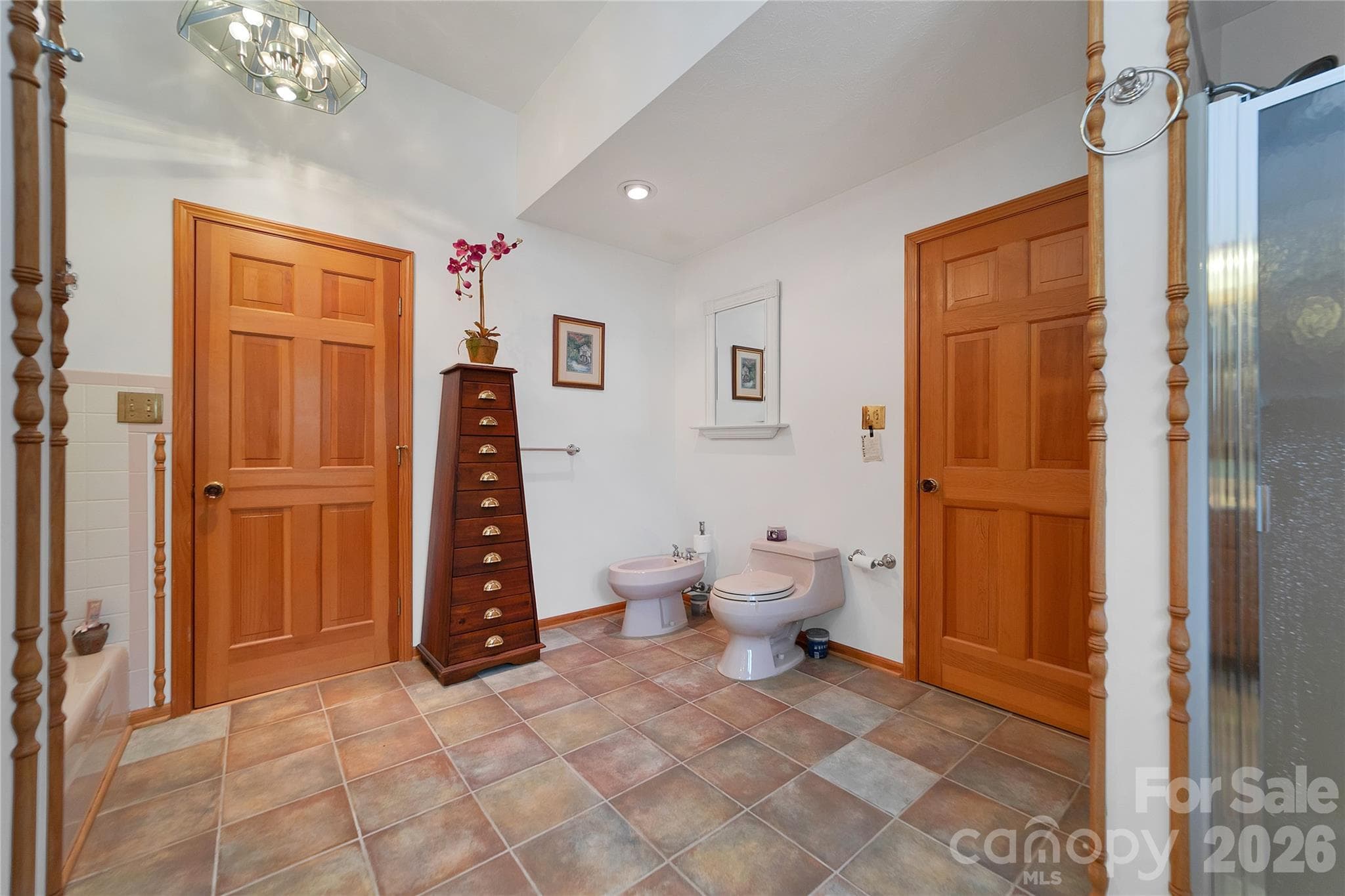 The primary bathroom sports a low sided garden tub, a bidet toilet, and a regular toilet. Ceramic tile floor. - 275 Hubbard Hollow Road, Rosman