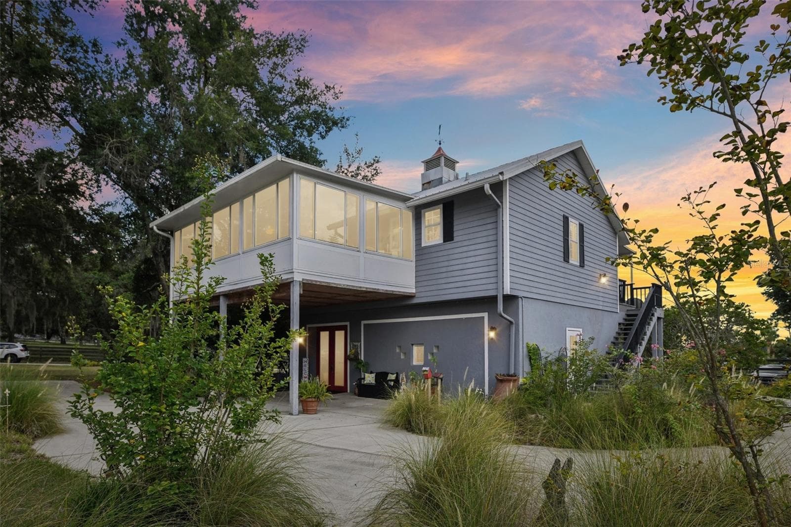 Back & side view of house at dusk - 18249 ROSE ST, GROVELAND