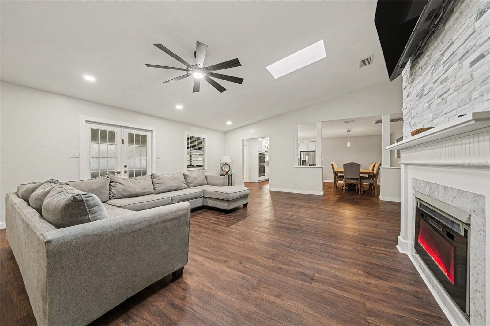 Spacious Family Room featuring dual Electric Fireplace & Stone tile accent wall - 1592 SKYLINE DR, KISSIMMEE
