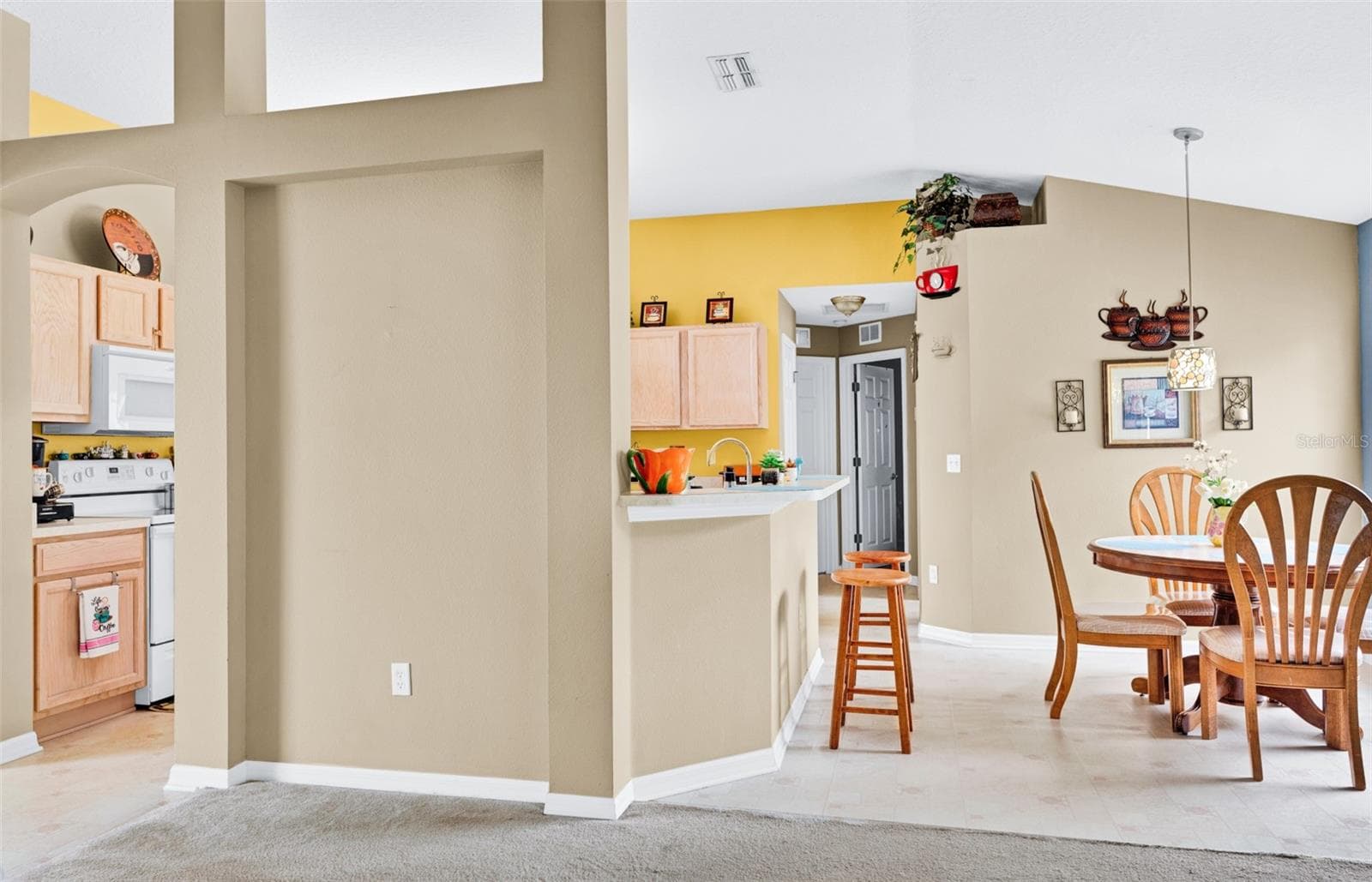 View of kitchen and breakfast area from living room - 7 PHOENIX LN, PALM COAST
