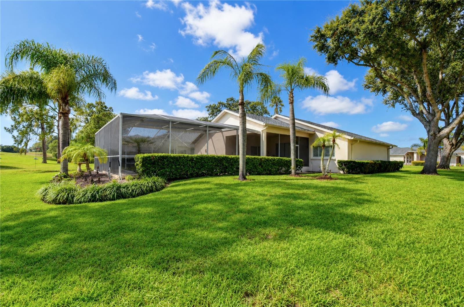 Private outdoor space combines poolside relaxation with scenic 6th fairway views. - 5602 ROCKFIELD LOOP, VALRICO