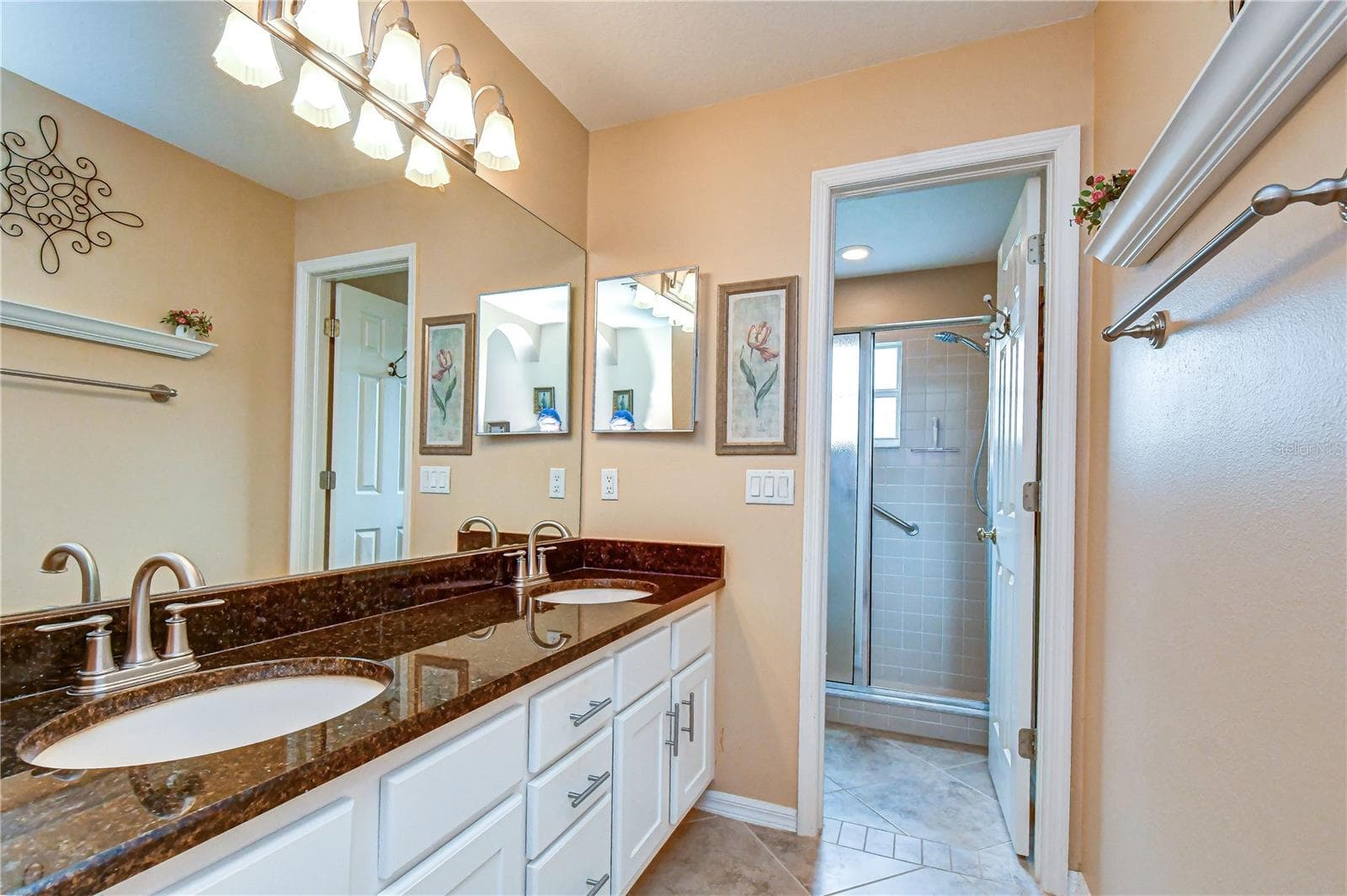 En-suite bath featuring dual vanities and comfortable finishes. - 5602 ROCKFIELD LOOP, VALRICO