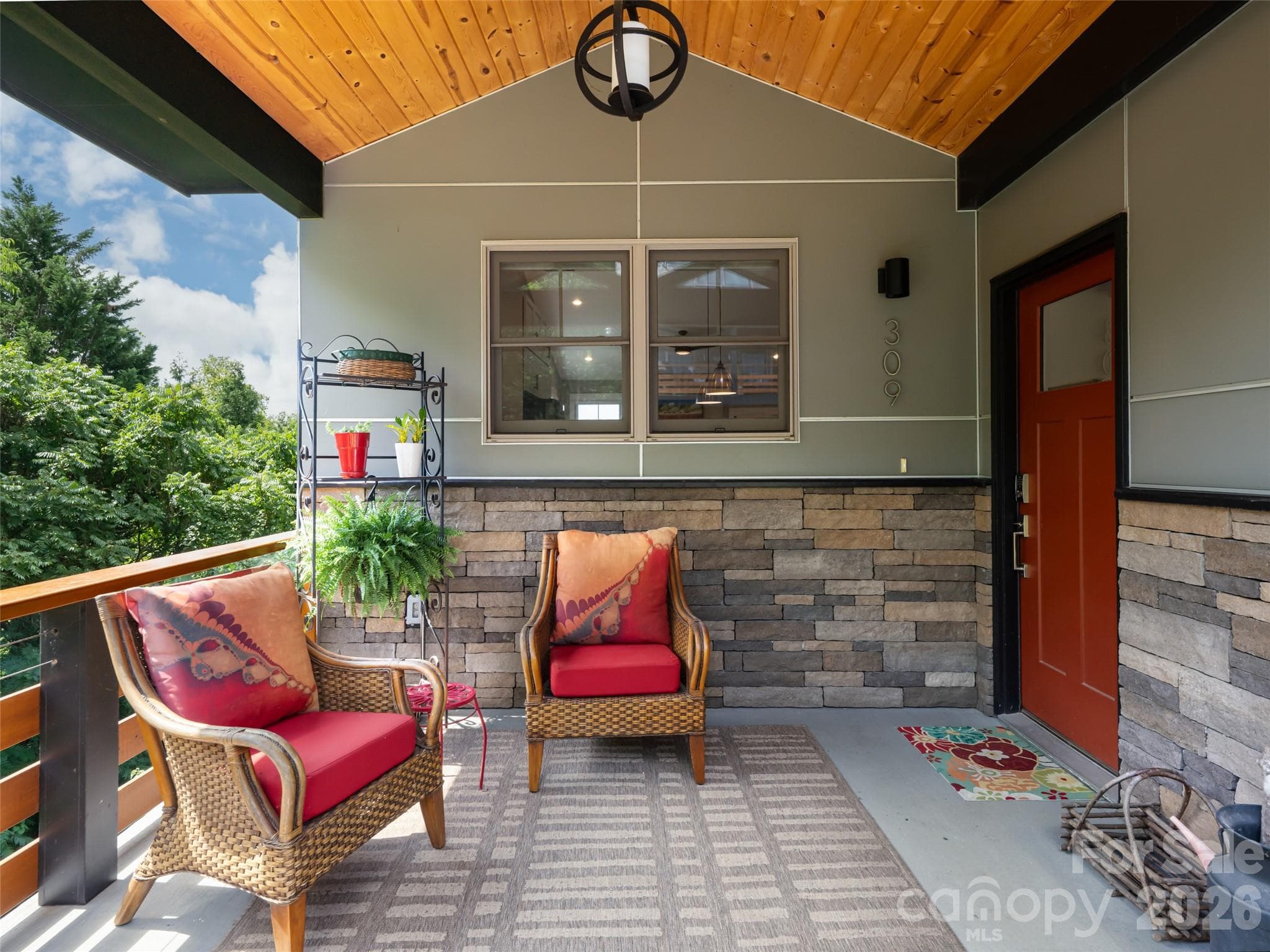 Front porch area with double windows from the kitchen allowing visual access inside or out. - 309 Ava Lane, Asheville