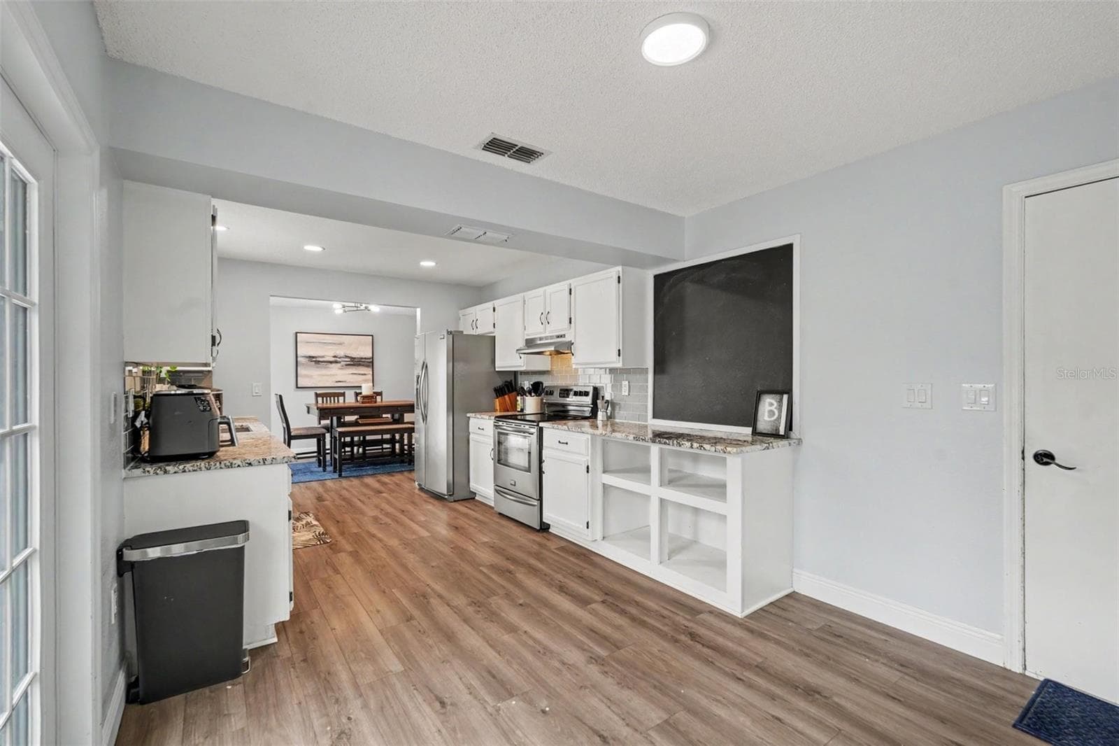 Kitchen with French doors to the pool deck - 736 SANDY CREEK DR, BRANDON