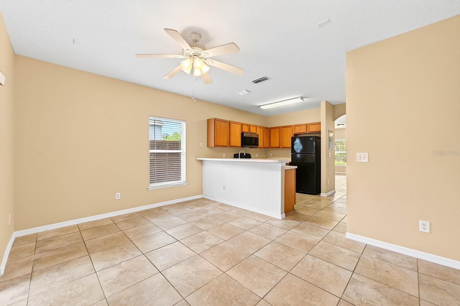 The kitchen is ideally situated between a light filled family room and the open living and dining. - 102 WILTON CIR, SANFORD