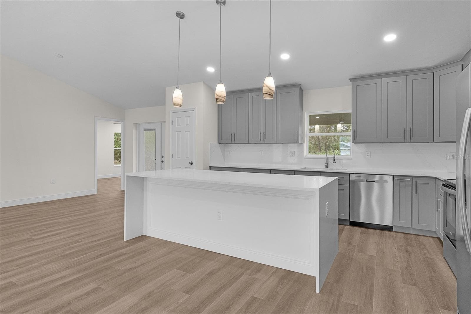 Image your kitchen bar stools here. Notice the large pantry and larger cabinets that go all the way to the ceiling - 8277 SE 158TH ST, SUMMERFIELD