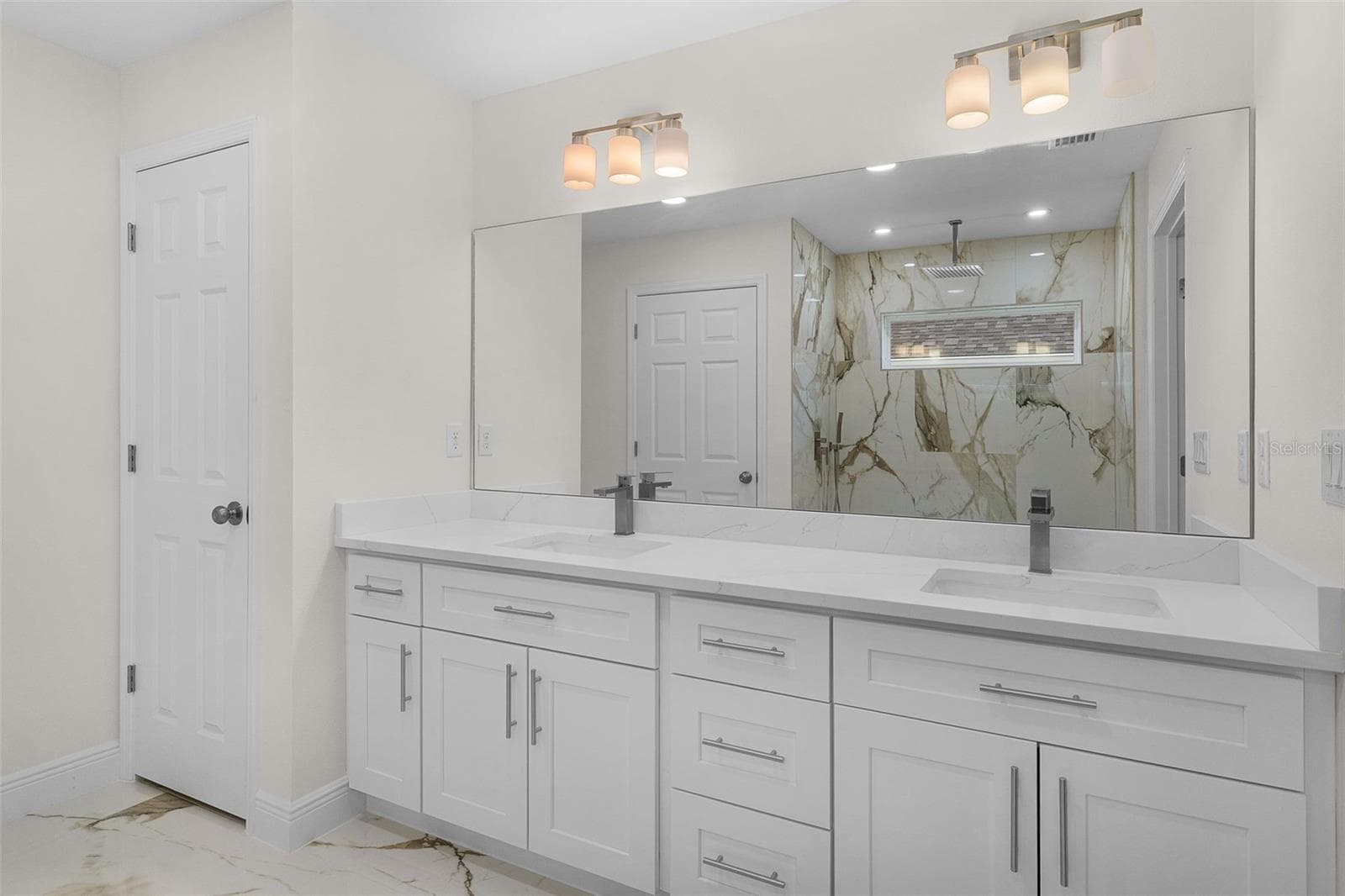 Primary En Suite- Double sinks, linen closet, beautiful ceramic tile on floor and shower. - 8277 SE 158TH ST, SUMMERFIELD