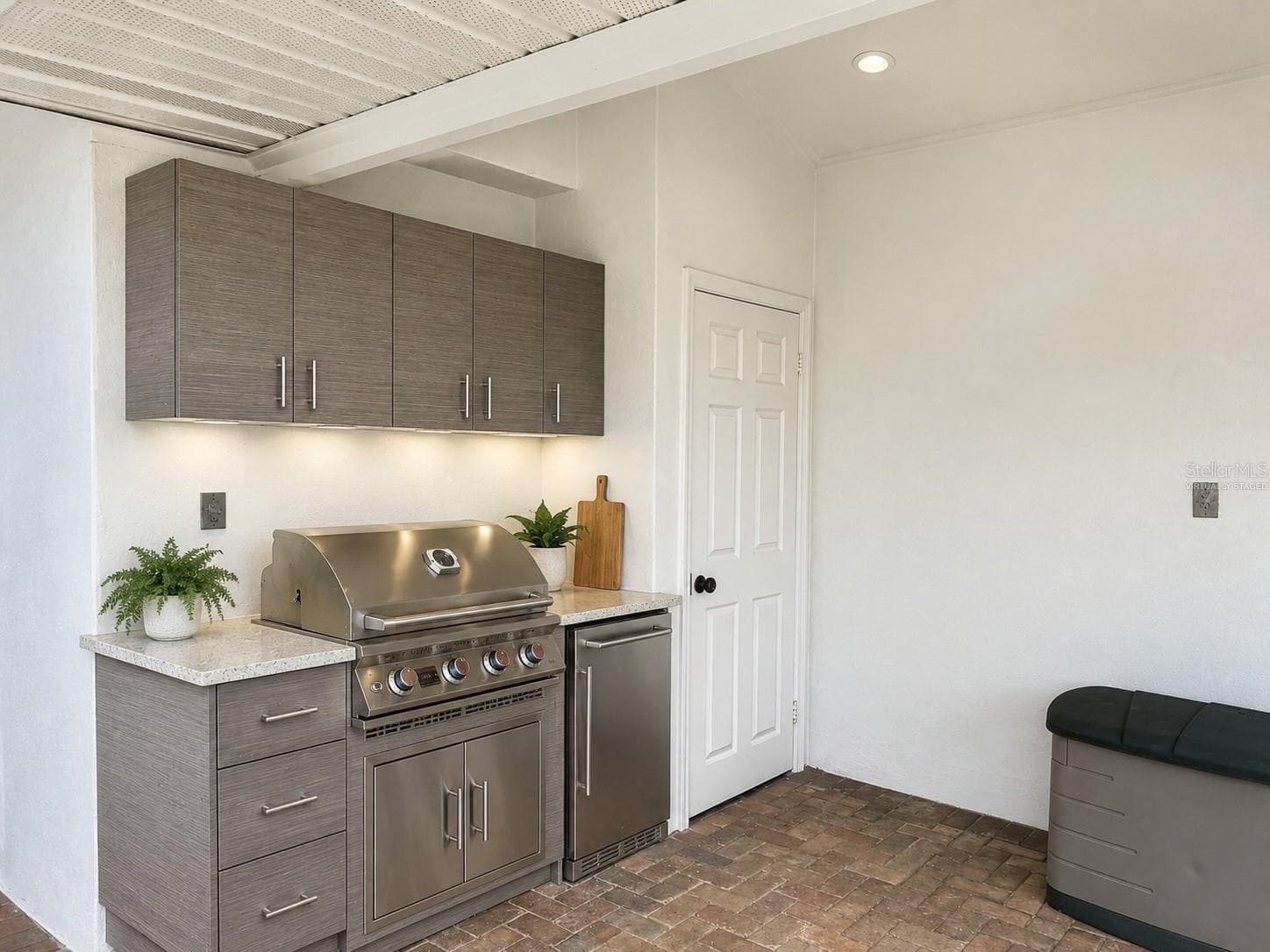 Virtually staged rendering of outdoor kitchen set up where the wall has plumbing for gas and electrical. - 2936 68TH AVE S, ST PETERSBURG