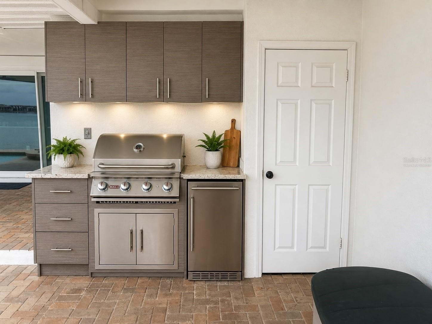 Virtually staged rendering of outdoor kitchen set up where the wall has plumbing for gas and electrical. - 2936 68TH AVE S, ST PETERSBURG
