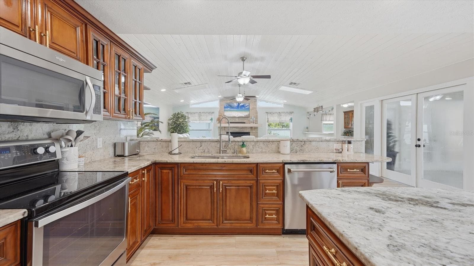 Kitchen sink overlooks family room and has a view of the TV above the fireplace - 15127 PENNINGTON RD, TAMPA