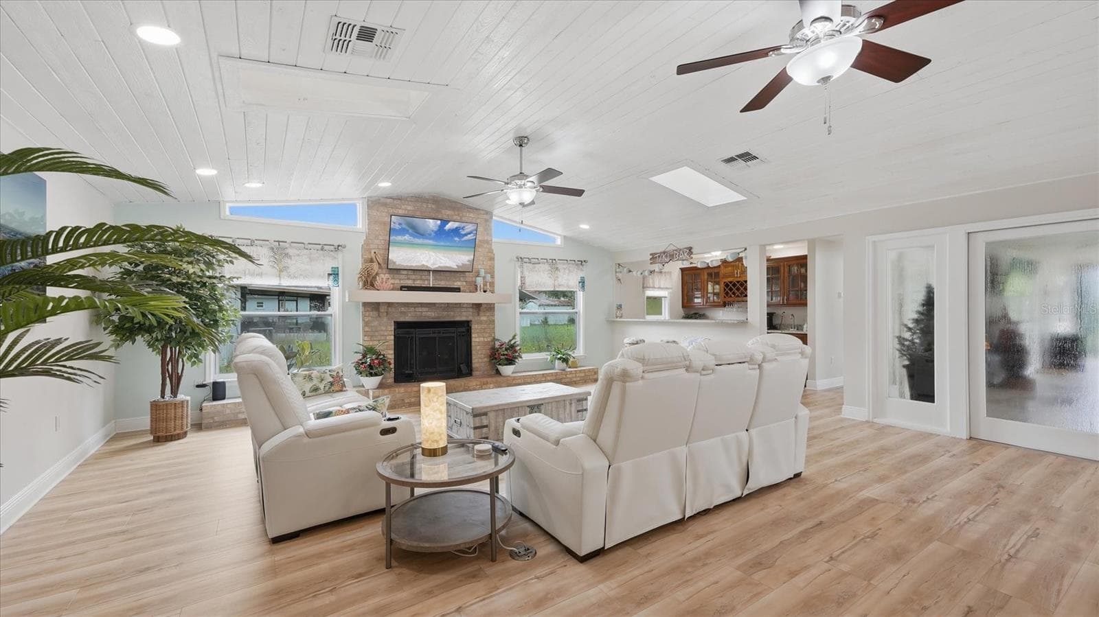 Beautiful family room boasts a shiplap style ceiling with multiple skylights as well as transom windows that allow natural light to shine in - 15127 PENNINGTON RD, TAMPA