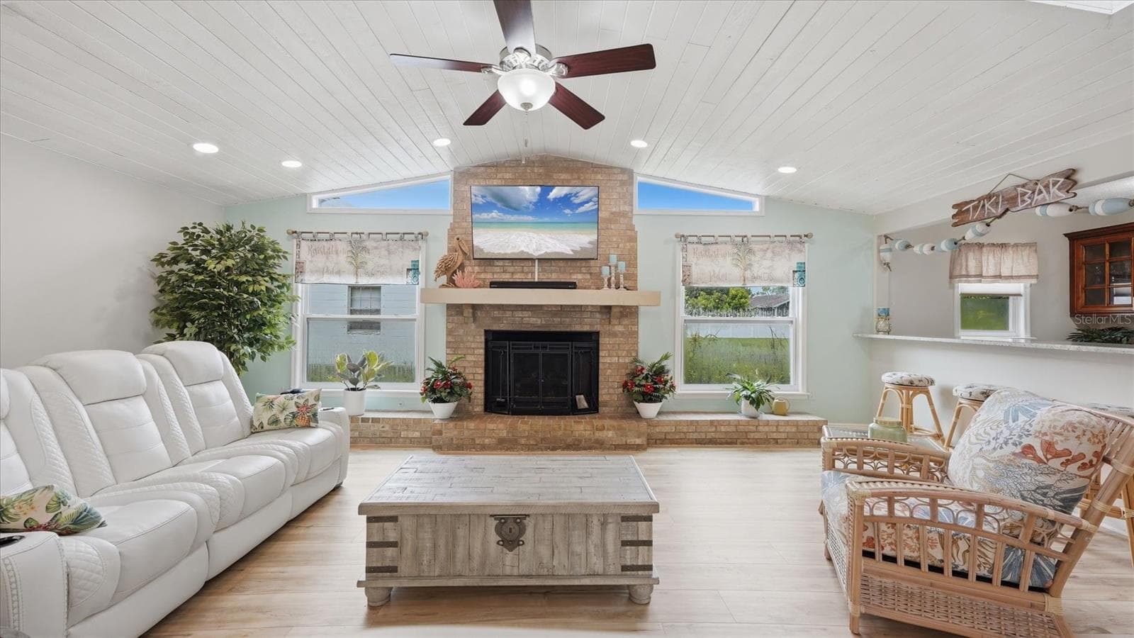 Gas fireplace with large mantle and plant shelving in front of each window - 15127 PENNINGTON RD, TAMPA