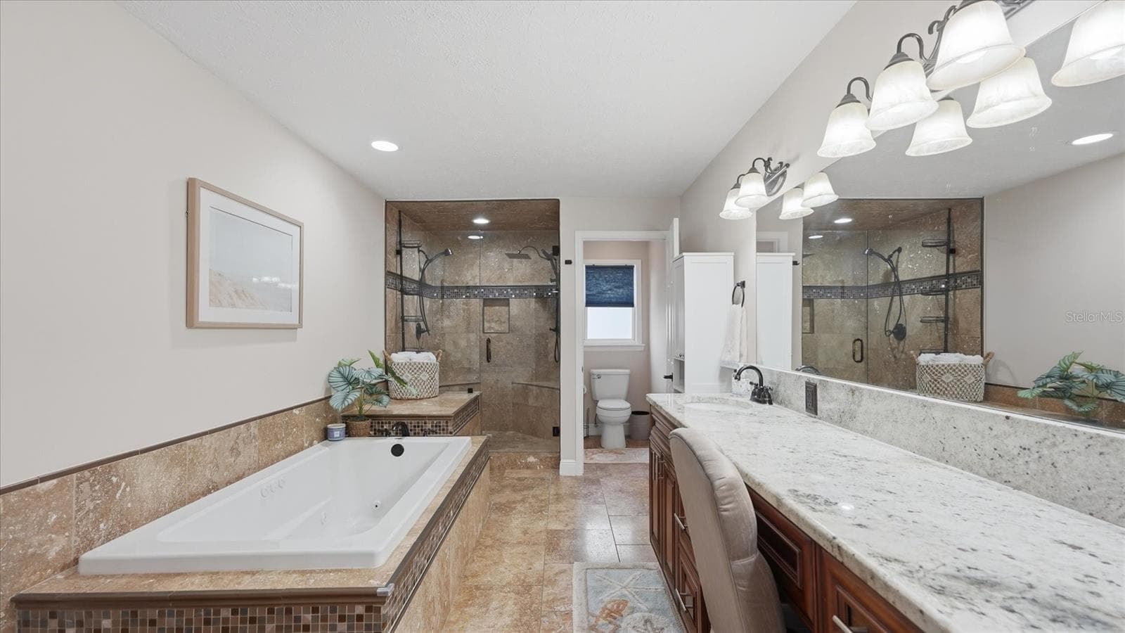Jetted tub plus walk in shower with floor to ceiling tile, dual shower heads, built in seating and a seamless glass enclosure. - 15127 PENNINGTON RD, TAMPA