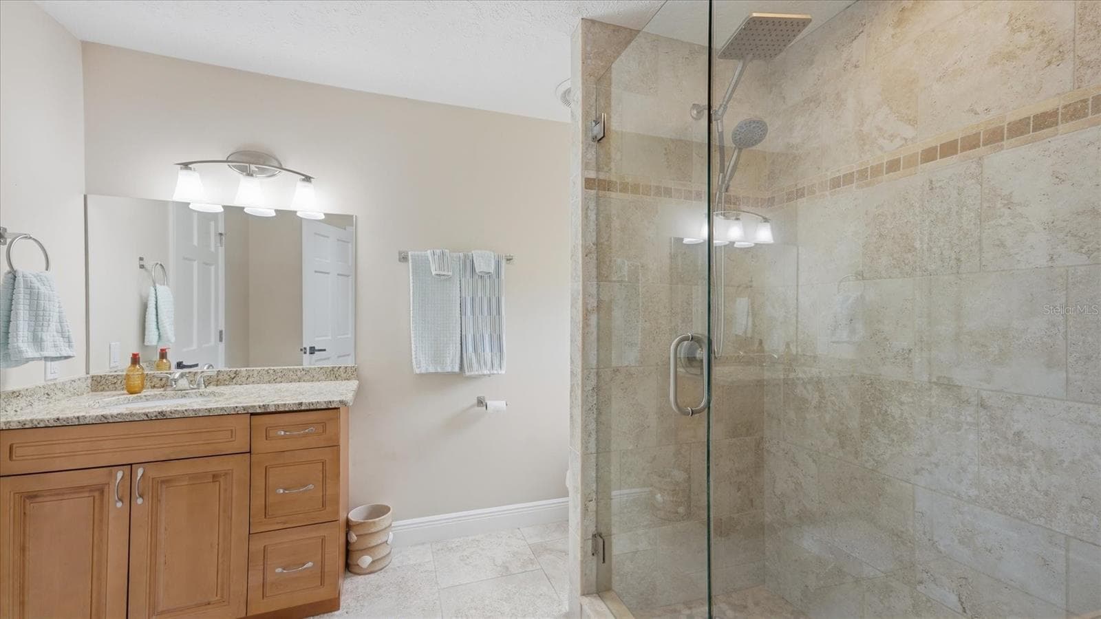 Single vanity features wood cabinet, drawers and granite countertop - 15127 PENNINGTON RD, TAMPA