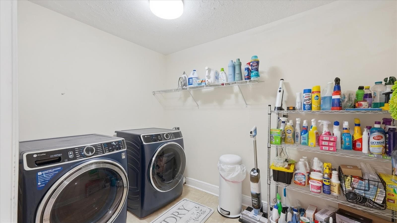 Laundry Room comes with newer (2024) Front Load GE Profile W/D and offers extra storage space - 15127 PENNINGTON RD, TAMPA