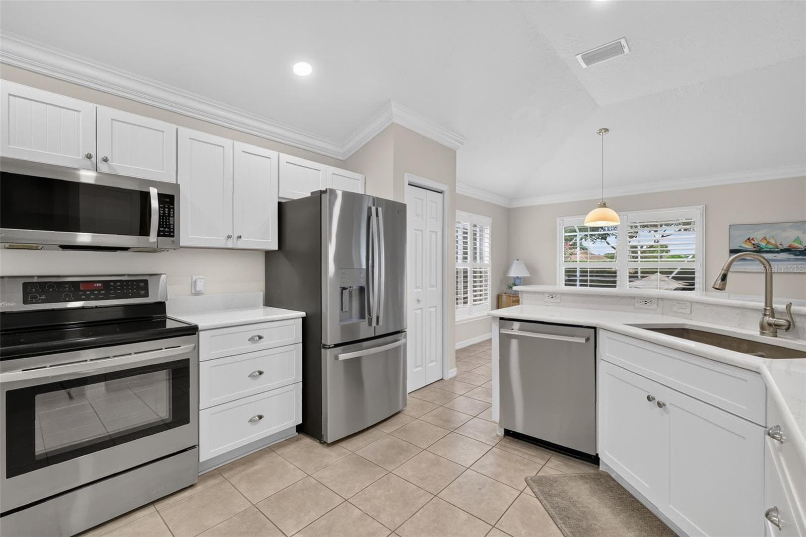 Updated white cabinets and stainless steel appliances - 1218 CAMERO DR, LADY LAKE