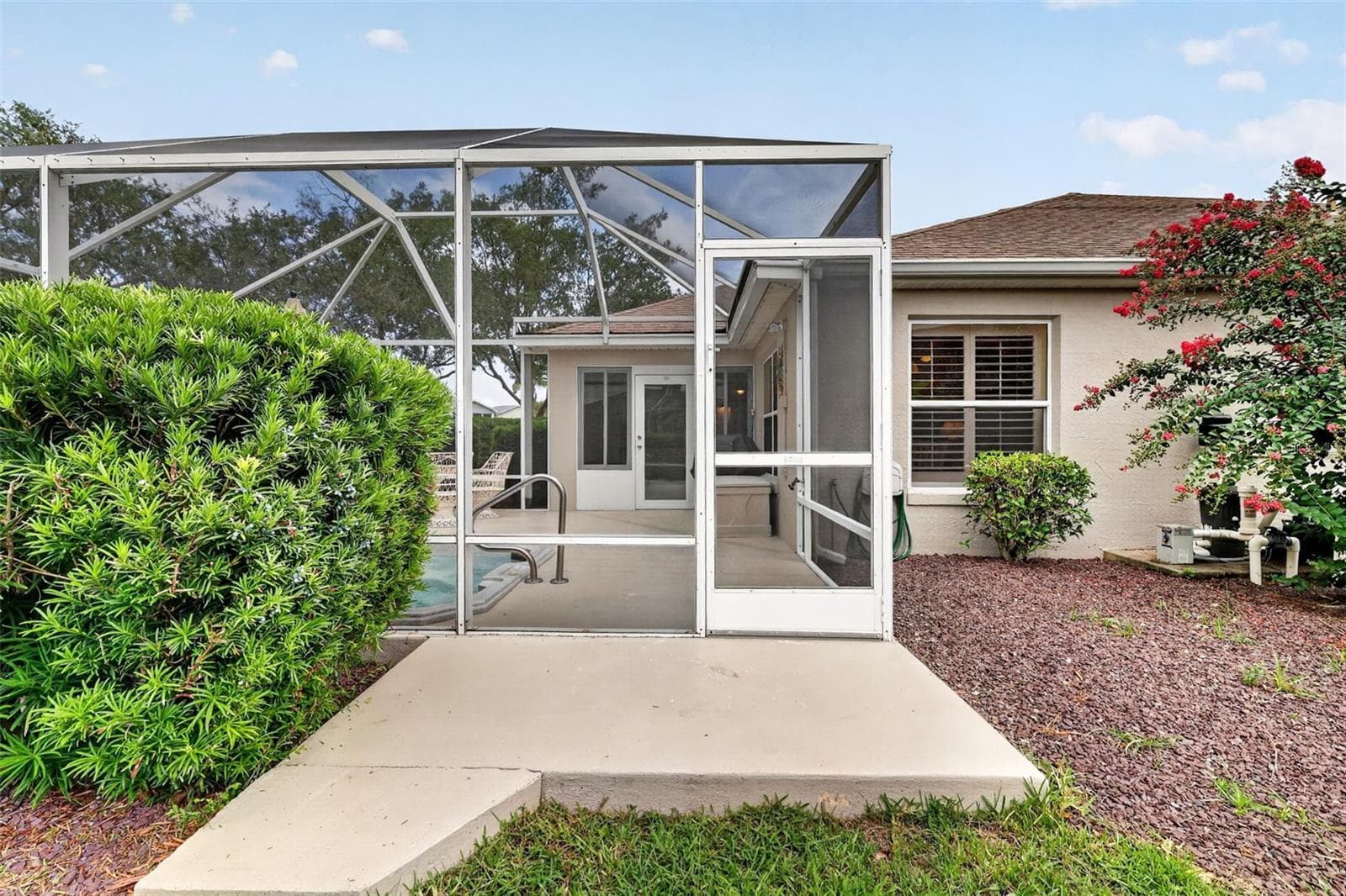 Side of pool area with small grilling patio - 1218 CAMERO DR, LADY LAKE