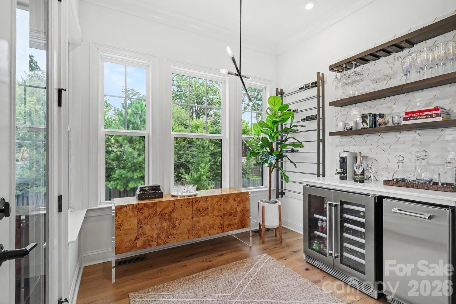 This custom bar area features built-in cabinetry, a dedicated beverage refrigerator, and an ice maker—all thoughtfully integrated by the current owner to create the perfect space for entertaining. - 2505 Kenmore Avenue, Charlotte