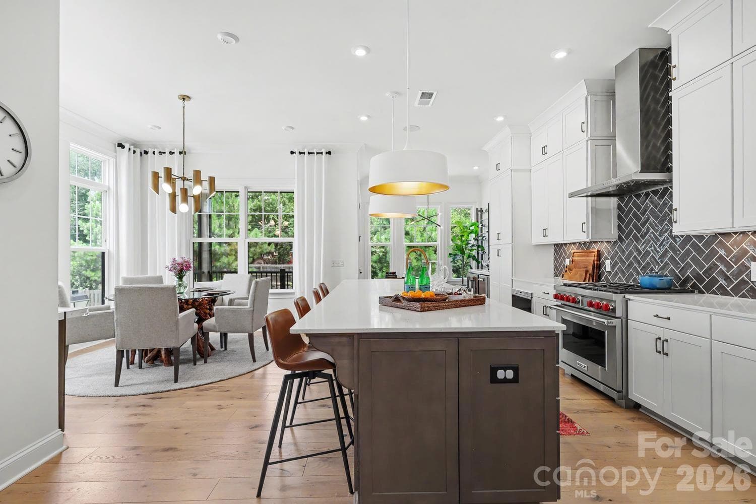 This kitchen, breakfast nook, and bar space feature exquisite finishes, including high-end upgraded appliances and sophisticated custom light fixtures. - 2505 Kenmore Avenue, Charlotte