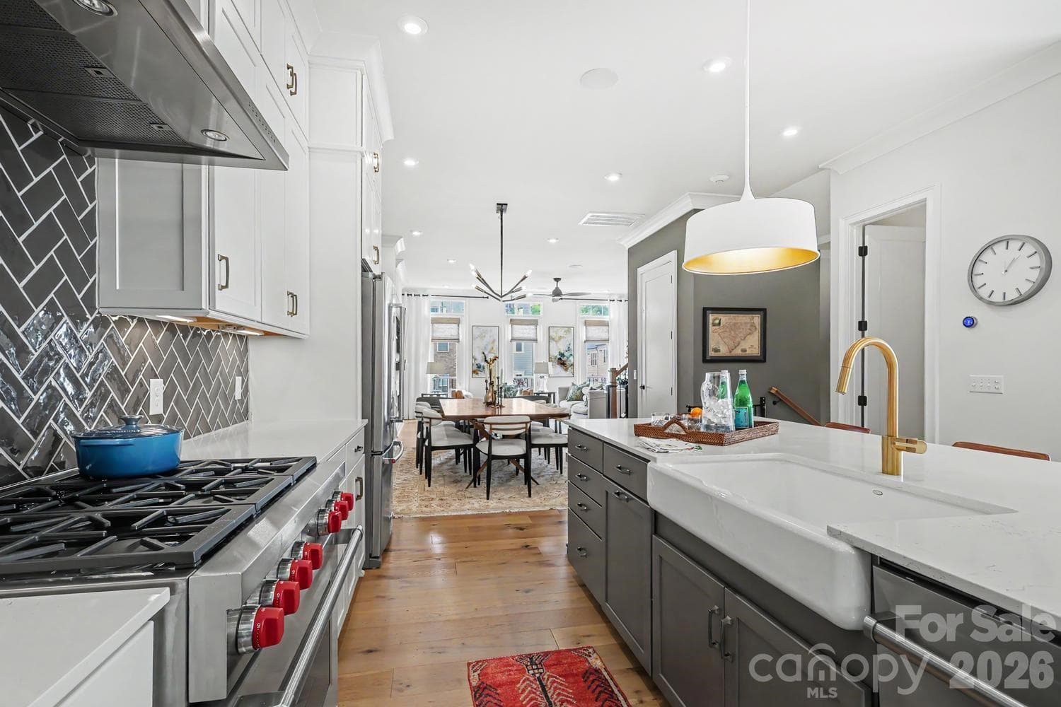 A Wolf gas stove and stainless steel hood serve as the focal point of this high-end kitchen, highlighting its premium design and professional-grade appliances. - 2505 Kenmore Avenue, Charlotte