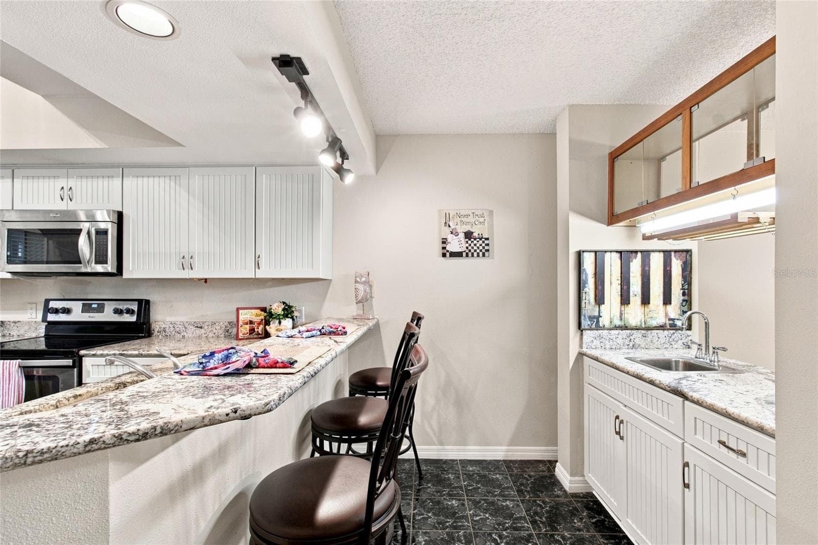 Kitchen w/ Breakfast Bar Stools and wet bar - 2599 DOLLY BAY DR #306, PALM HARBOR