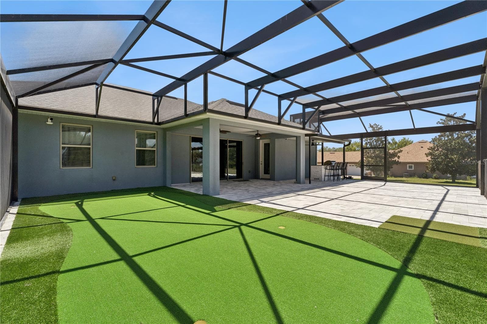 Putting green on pool patio - 18145 GREAT BLUE HERON DR, GROVELAND