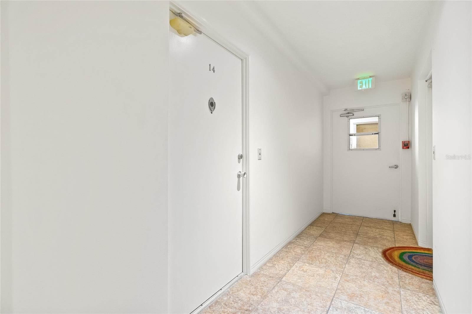 The door to enter the residence is to the left, #14. The door straight ahead is how you enter the building. This is a secured door that requires a key to access the hallway. - 1012 N SHORE DR NE #14, ST PETERSBURG