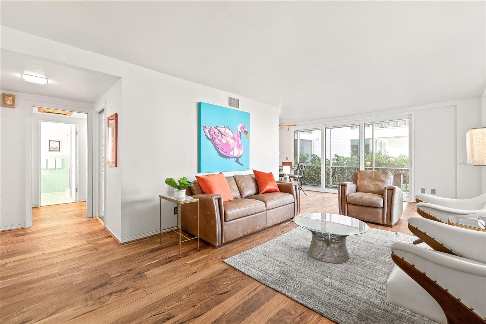The opening to the left is the bathroom, and a hallway leads to the bedroom. To the right is the combo dining/ living space, and you can see the sliding doors that lead to the patio. - 1012 N SHORE DR NE #14, ST PETERSBURG