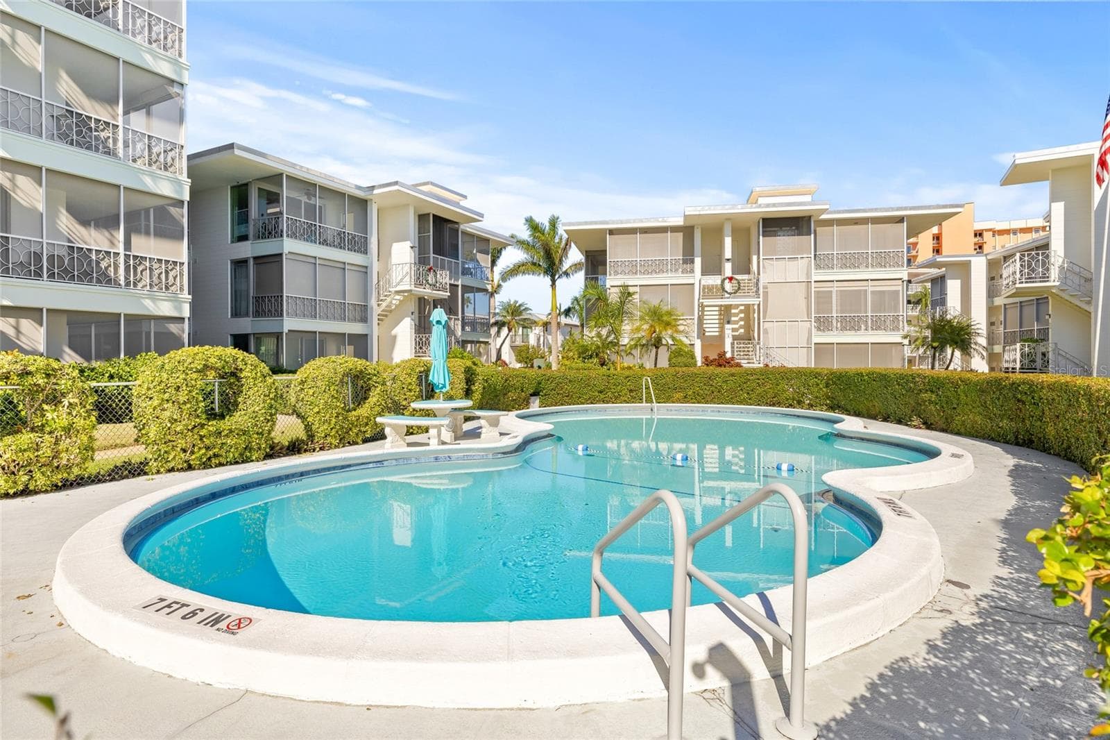 The community pool is generously sized and has some furnishings. Plenty of landscaping surrounds the pool, giving it a private feel. - 1012 N SHORE DR NE #14, ST PETERSBURG
