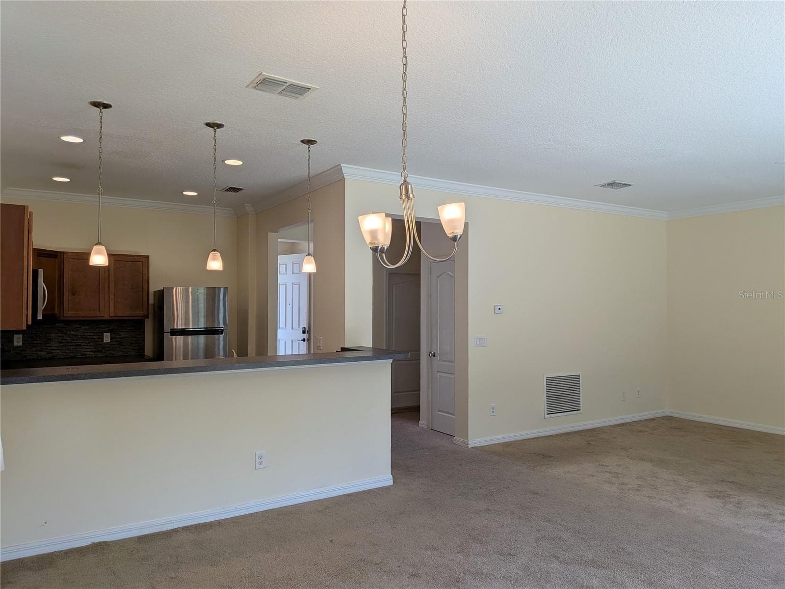 view of kitchen and living room from dining room - 1187 CHERVIL DR, POINCIANA