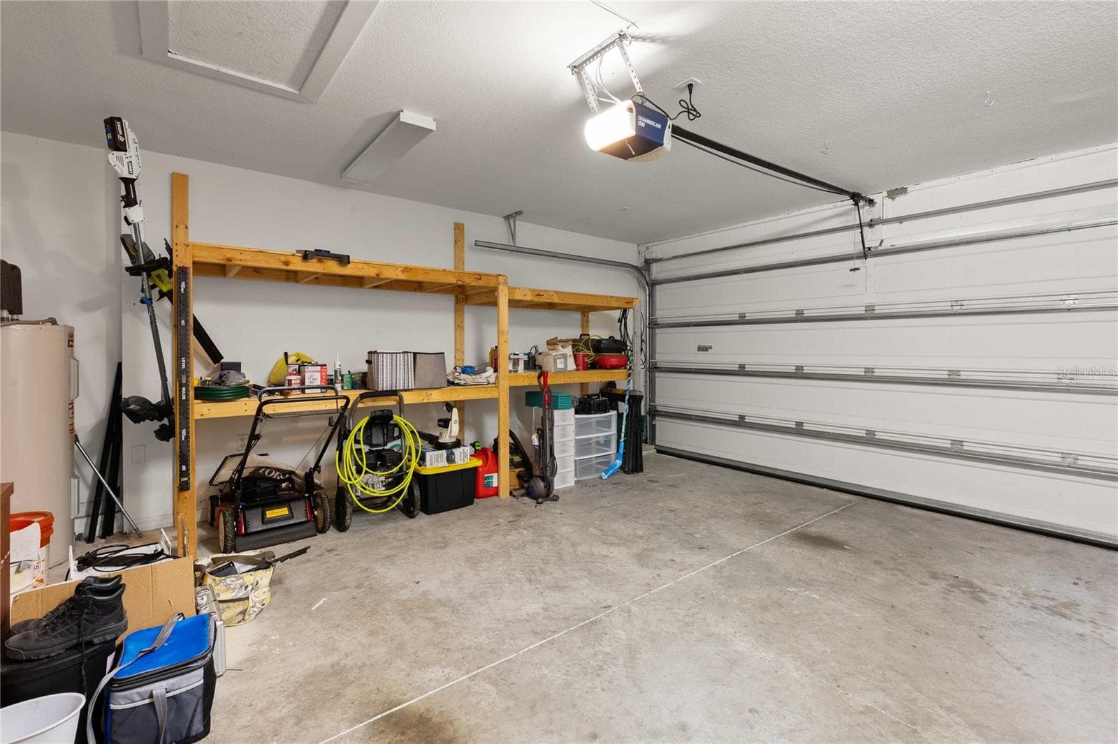 Garage with shelving - 14423 FINSBURY DR, SPRING HILL