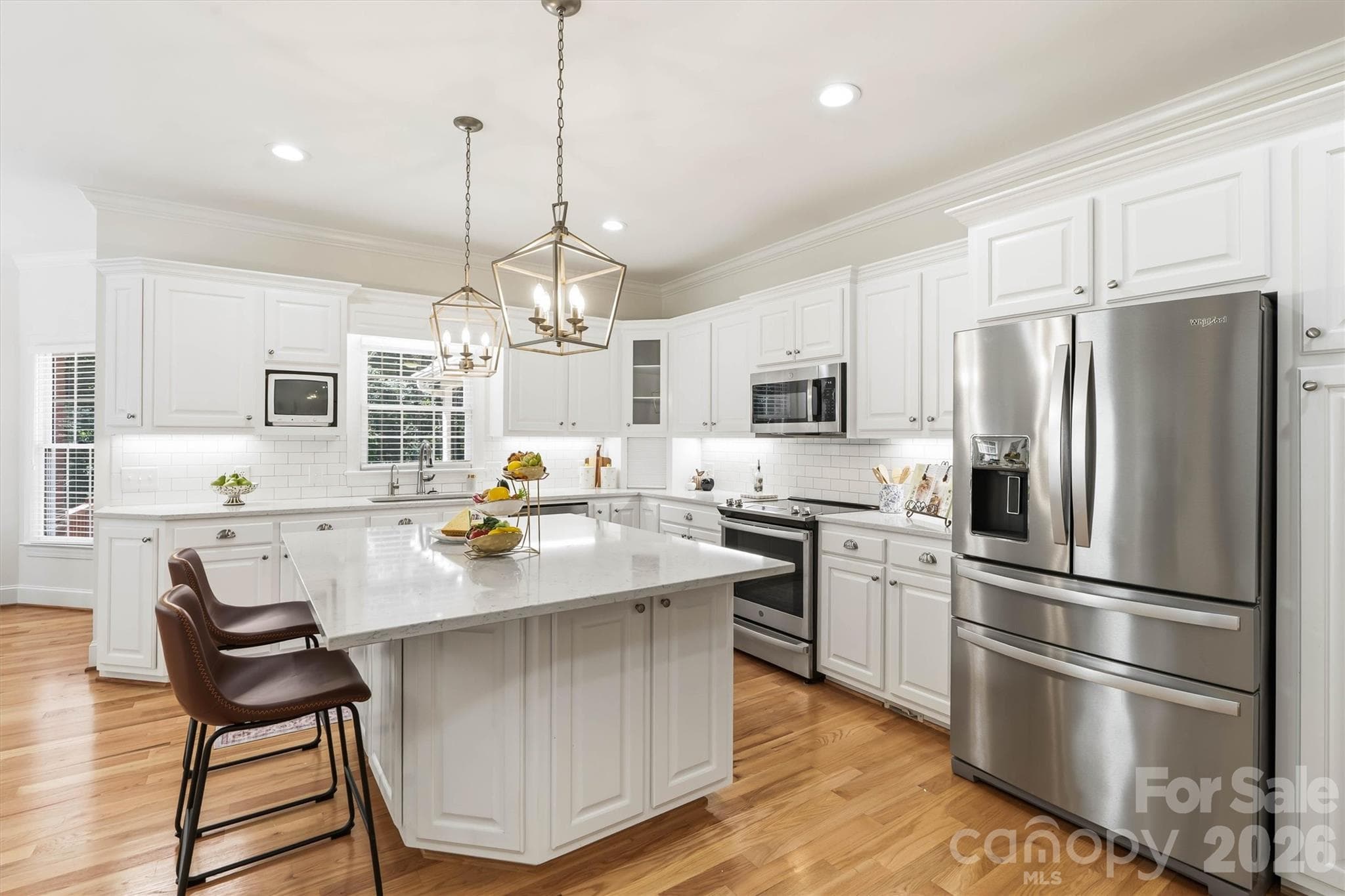Gourmet kitchen with custom cabintry, quartz countertops and an immense island. The kitchen is the "heart" of many homes and this one does not disappoint. - 675 Heather Drive, Lincolnton
