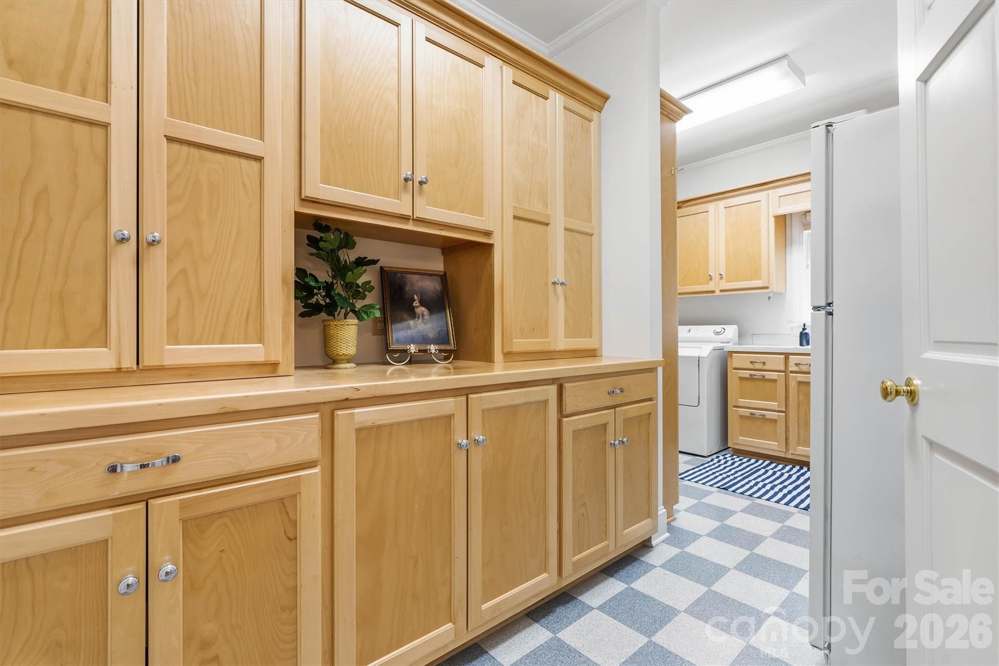 This fabulous walk-in pantry and laundry room off the kitchen is ideal for storing all of the large kitchen equipment. There is even a second refrigerator to house extra food and drinks - 675 Heather Drive, Lincolnton