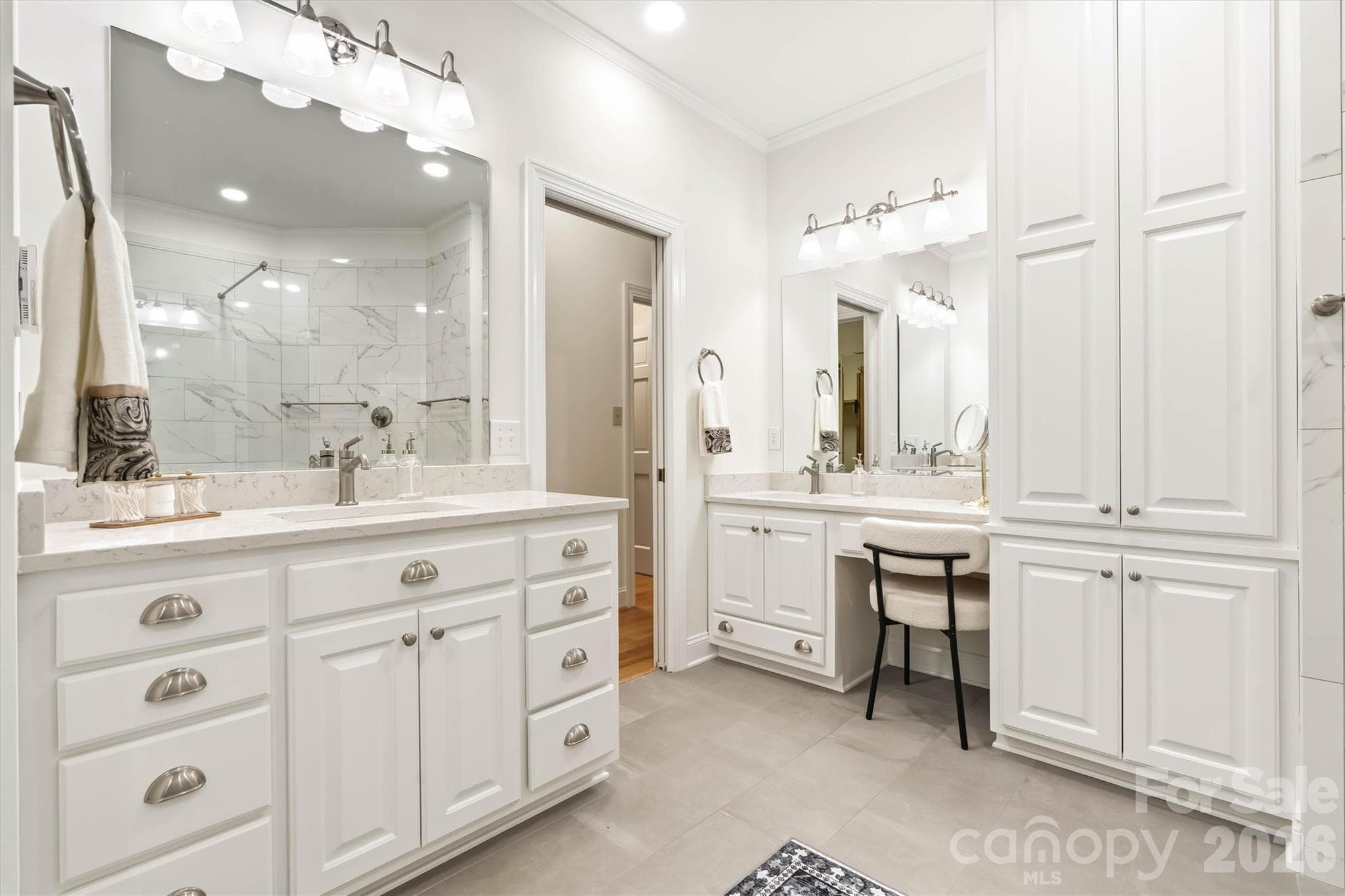 Custom cabinetry in your primary ensuite bath with dual vanities and a makeup counter - 675 Heather Drive, Lincolnton