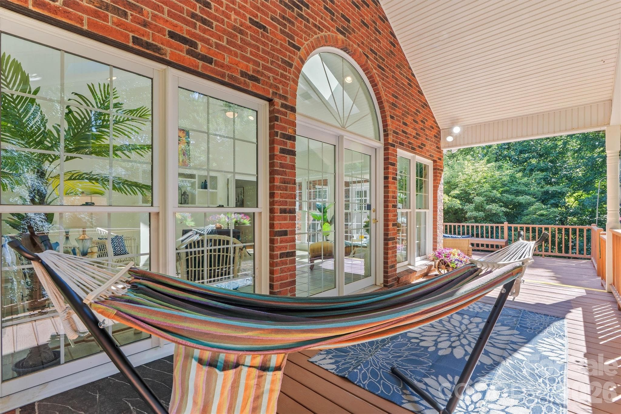 Outdoors, off the sunroom, enjoy this covered area overlooking your priate backyard. - 675 Heather Drive, Lincolnton