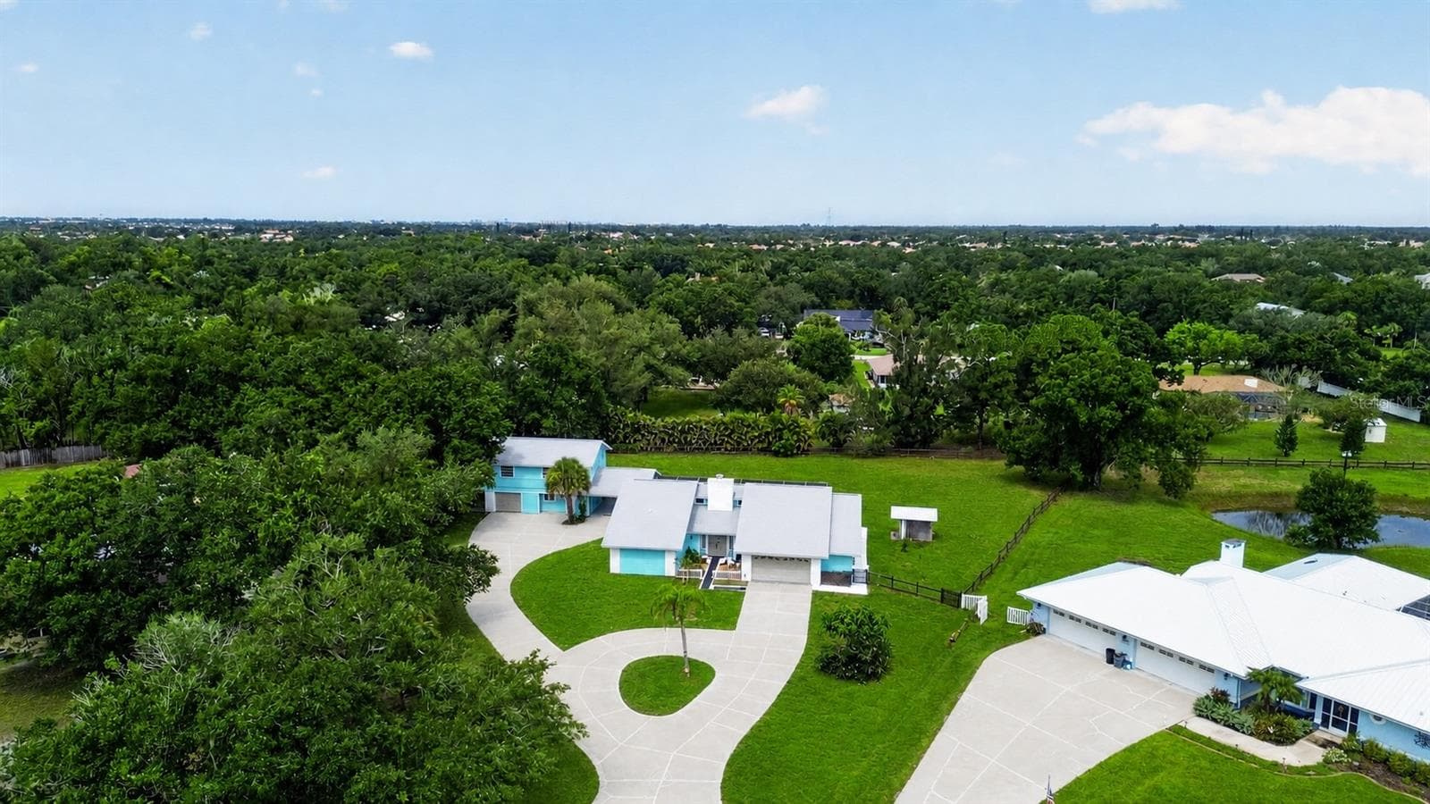 Aerial view of the expansive property and surrounding area. - 1305 GREENFIELD CIR, VENICE