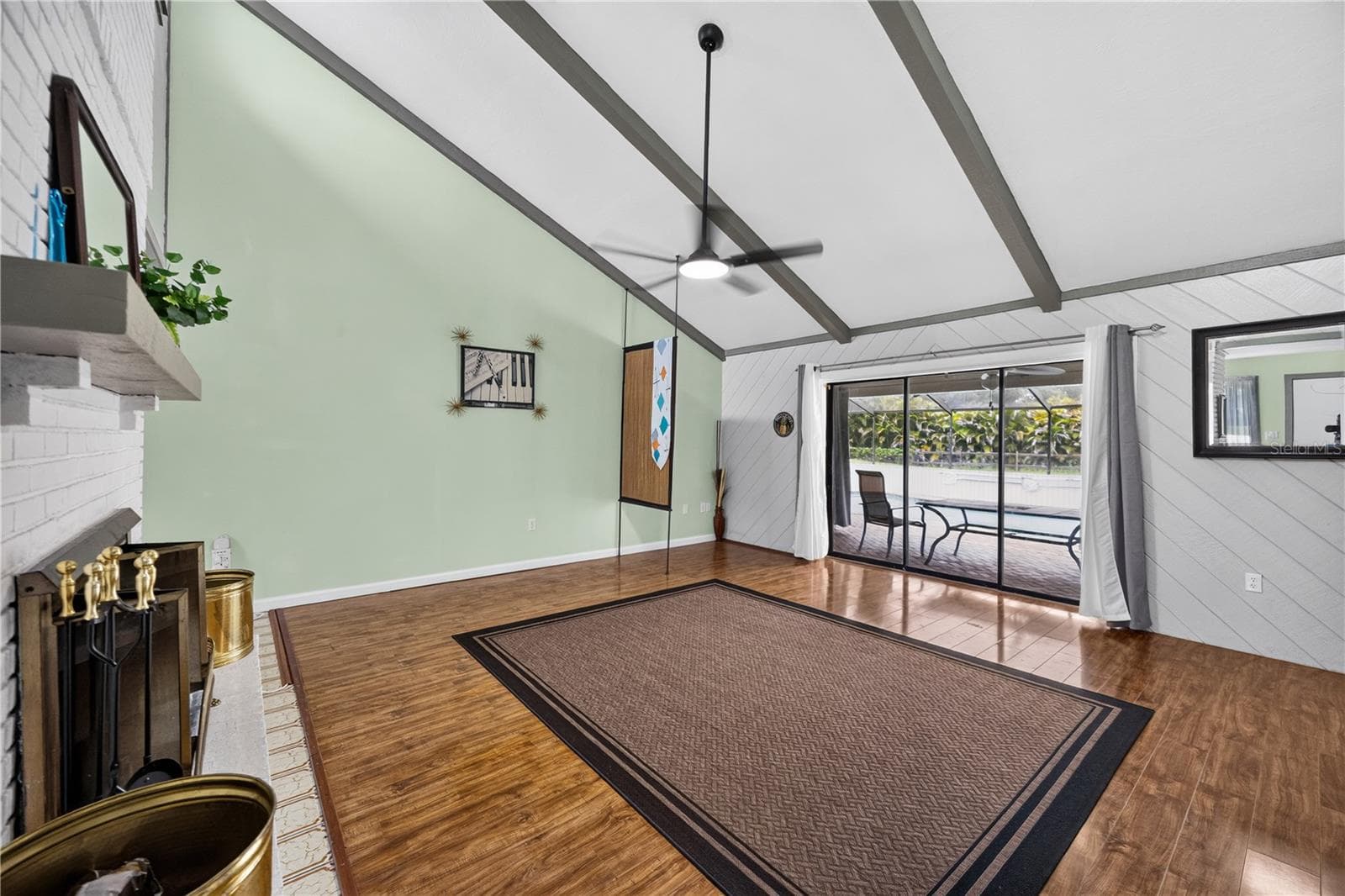 Great room with fireplace, TV and open floor plan. - 1305 GREENFIELD CIR, VENICE