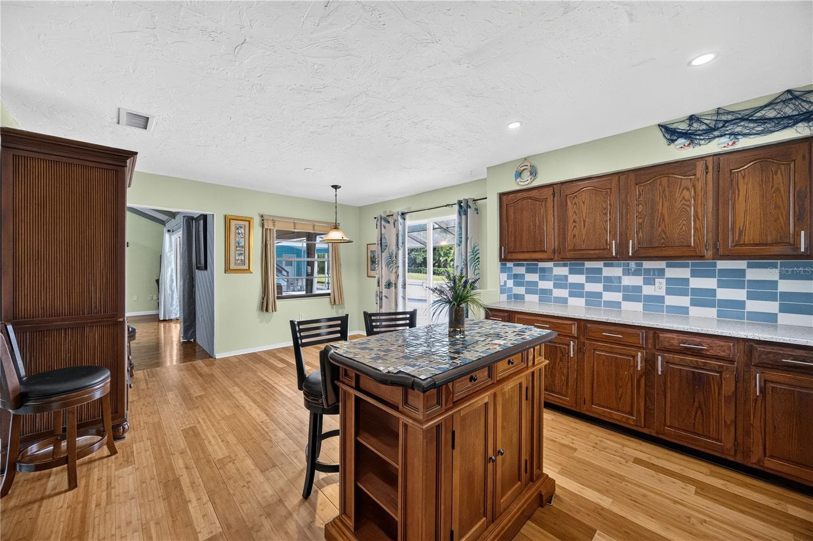 Kitchen with breakfast bar and open layout. - 1305 GREENFIELD CIR, VENICE