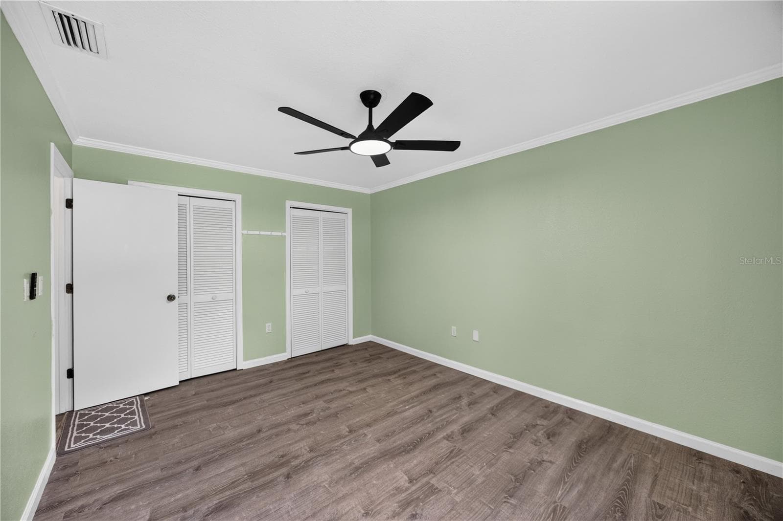Unfurnished secondary bedroom with dual closets. - 1305 GREENFIELD CIR, VENICE