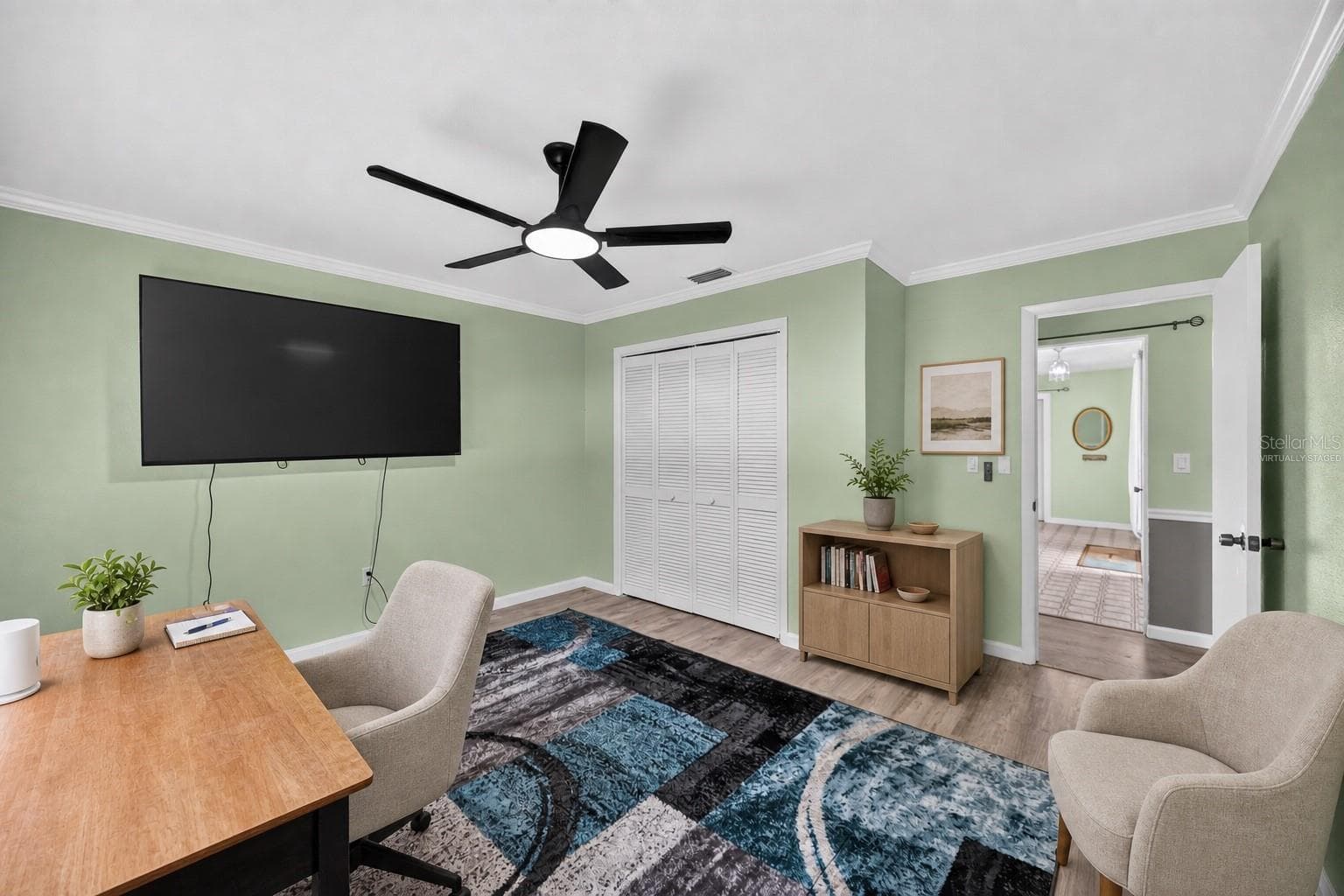 Virtually staged - Home office with desk and guest seating. - 1305 GREENFIELD CIR, VENICE
