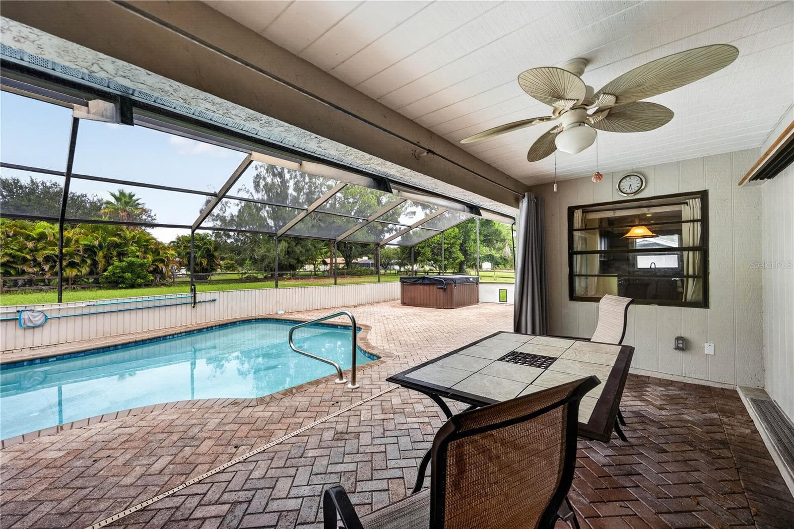 Covered lanai overlooking the screened pool. - 1305 GREENFIELD CIR, VENICE