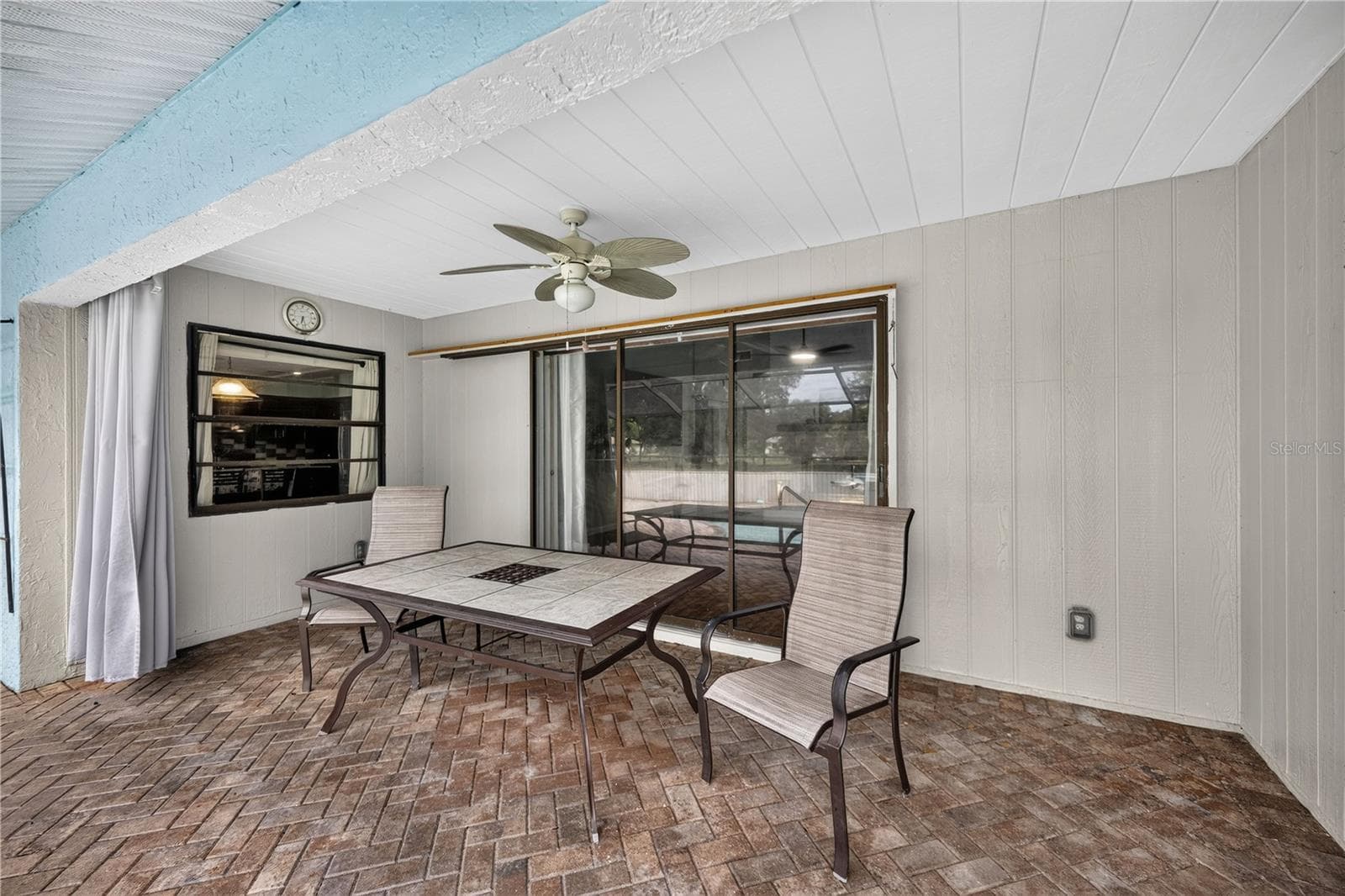 Covered patio lounge beside the pool. - 1305 GREENFIELD CIR, VENICE