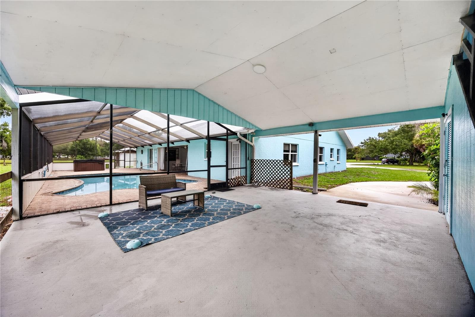 Covered lanai with multiple seating areas. - 1305 GREENFIELD CIR, VENICE
